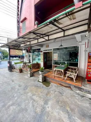 a store front with a ping pong table on a patio at Ratanawong Place 815 in Bangkok