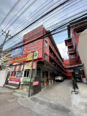 a red building with a sign on the side of it at Ratanawong Place 815 in Bangkok