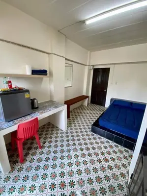 a room with a bed and a table and a couch at Ratanawong Place 815 in Bangkok