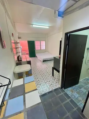 a room with a room with a bed and a door at Ratanawong Place 513 in Bangkok