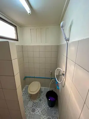 a small bathroom with a toilet in a stall at Ratanawong Place 556 in Bangkok