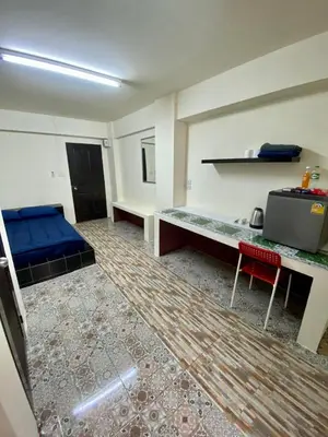 a room with a bed and a desk in it at Ratanawong Place 804 in Bangkok