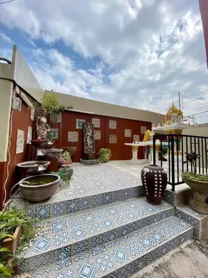 a building with a courtyard with vases on it at Ratanawong Place 406 in Bangkok