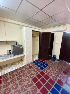 a kitchen with a colorful floor in a room at Ratanawong Place 405 in Bangkok