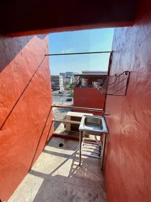 a room with a table and a chair on a balcony at Ratanawong Place 404 in Bangkok