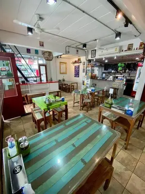 a restaurant with a table and tables and chairs at Ratanawong Place 404 in Bangkok