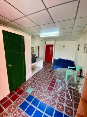 a room with a green door and a tile floor at Ratanawong Place 404 in Bangkok