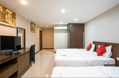 a hotel room with two beds and a flat screen tv at IRAQI HOTEL in Makkasan