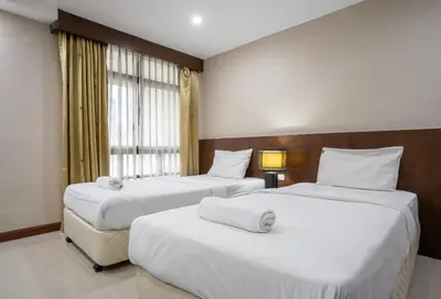 a hotel room with two beds and a window at IRAQI HOTEL in Makkasan