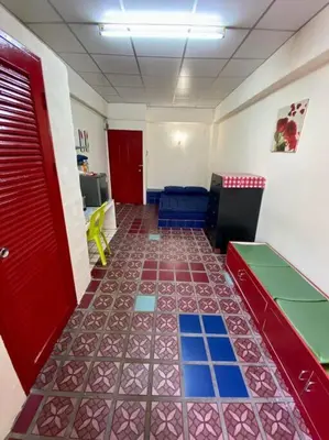 a room with a red door and a tile floor at Ratanawong Place 304 in Bangkok