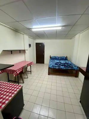 a room with a bed and two tables in it at Ratanawong Place 444 in Bangkok