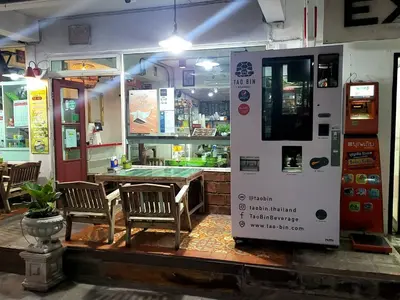 a restaurant with a table and a vending machine at Ratanawong Place 444 in Bangkok