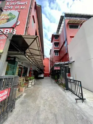an empty street in a city with buildings at Ratanawong Place 444 in Bangkok