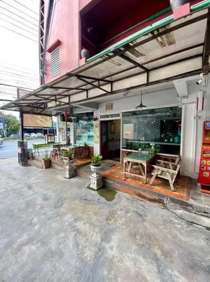 a store front with a ping pong table on a patio at Ratanawong Place 444 in Bangkok