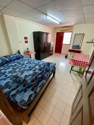 a bedroom with a large bed in a room at Ratanawong Place 557 in Bangkok