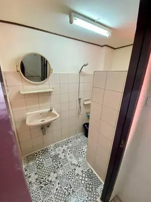 a bathroom with a sink and a mirror at Ratanawong Place 560 in Bangkok