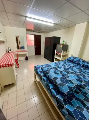 a bedroom with a blue bed in a room at Ratanawong Place 445 in Bangkok