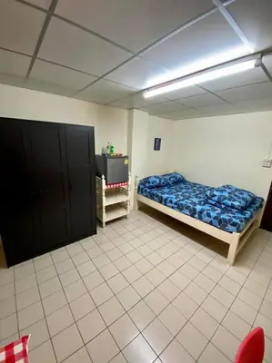a room with a bed and a tv in it at Ratanawong Place 445 in Bangkok