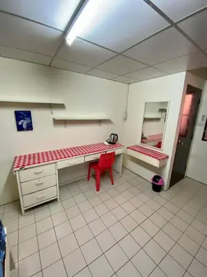 a room with a desk and a red chair at Ratanawong Place 445 in Bangkok