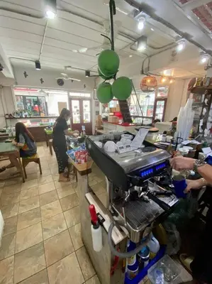 a kitchen with a counter with people in a restaurant at Ratanawong Place 445 in Bangkok