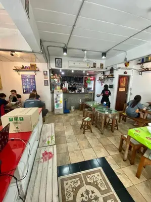a room with people sitting at tables in a restaurant at Ratanawong Place 445 in Bangkok