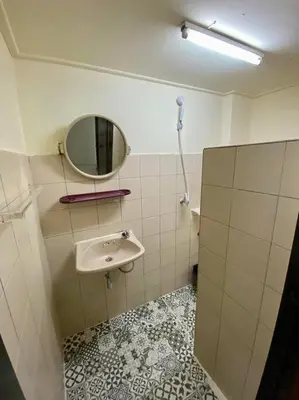 a bathroom with a sink and a mirror at Ratanawong Place 553 in Bangkok