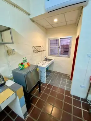 a kitchen with a counter and a sink in a room at Ratanawong Place 506 in Bangkok