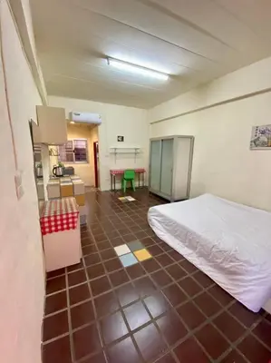 a room with a bed and a table in it at Ratanawong Place 506 in Bangkok