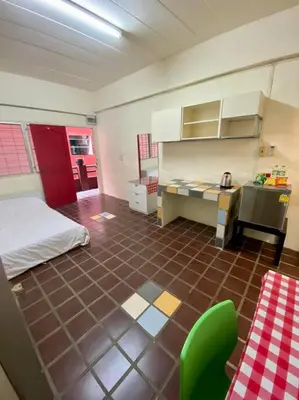 a room with a kitchen with a bed and a desk at Ratanawong Place 506 in Bangkok