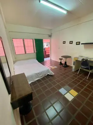 a room with a bed and a table in it at Ratanawong Place 516 in Bangkok