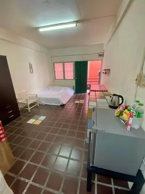 a room with a room with a bed and a tiled floor at Ratanawong Place 514 in Bangkok