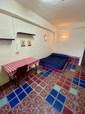 a room with a table and a bed in it at Ratanawong Place 401 in Bangkok