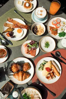 a bunch of plates of food on a table at Eastin Grand Hotel Phayathai in Bangkok