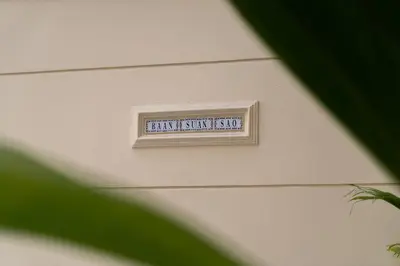 a sign on the side of a garage door at Baansuansao in Bang Rak