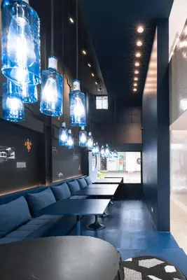 a row of benches in a room with blue lights at Speck Bangkok in Bangkok