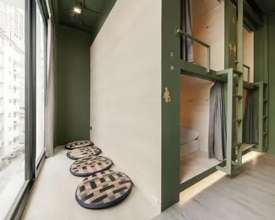 a room with four bunk beds and a toilet at Speck Bangkok in Bangkok