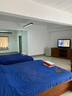 a bedroom with two beds and a flat screen tv at My Hotel Bangkok Noi in Bangkok Noi