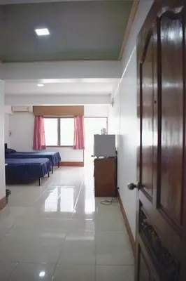 a room with two beds and a television in it at My Hotel Bangkok Noi in Bangkok Noi