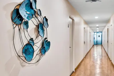 a painting of blue fish on a wall in a hallway at Chill Inn Bangkok in Bang Kapi