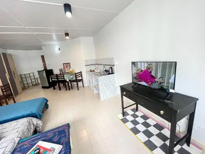 a living room with a flat screen tv on a piano at Impact Arena C3 Milo in Nonthaburi