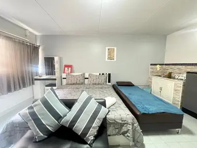 a bedroom with two beds and a couch at Impact Arena C3 Milo in Nonthaburi