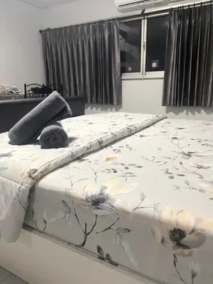 a white bed with flowers on it in a bedroom at Impact Arena C3 Milo in Nonthaburi