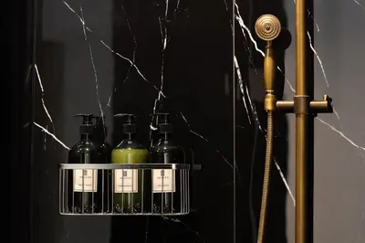 a shelf with four bottles of wine on it at Heaven Boutique Hotel in Bangkok