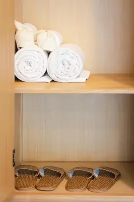 a shelf with white towels and baskets on it at Heaven Boutique Hotel in Bangkok