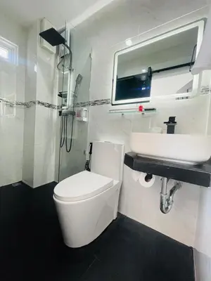 a bathroom with a toilet and a sink at Thonglor Suites Hotel in Bangkok