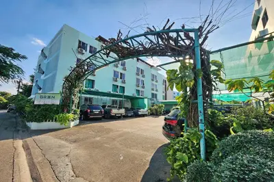 an archway on the side of a street with buildings at Green Apartment Kaset in Bangkok