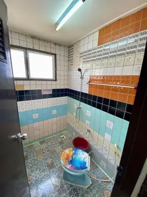 a bathroom with a toilet with a shower in it at Ratanawong Place 407 in Bangkok