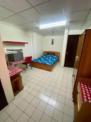 a room with a bed and a table and a desk at Ratanawong Place 552 in Bangkok