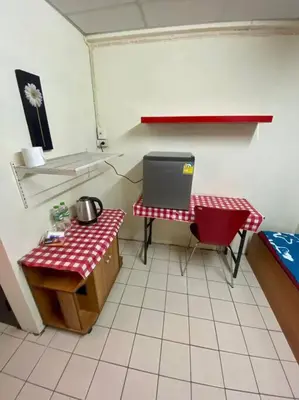 a room with a kitchen with a table and a laptop at Ratanawong Place 552 in Bangkok