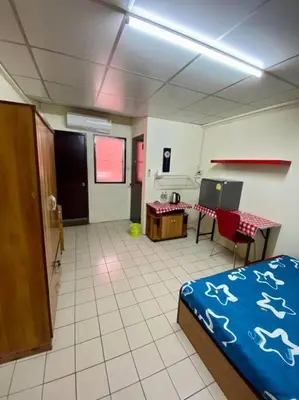 a room with a bedroom with a bed and a table at Ratanawong Place 559 in Bangkok